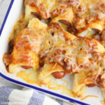 Chili Cheese Dog Casserole in a white enamelware casserole dish.