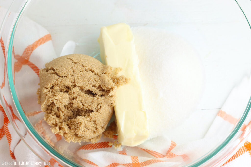 Sugar and butter in mixing bowl.