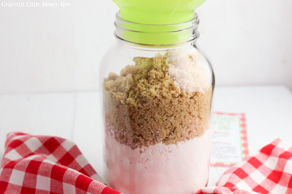 Flour, cornstarch, baking soda. and brown sugar layered in a quart mason jar.