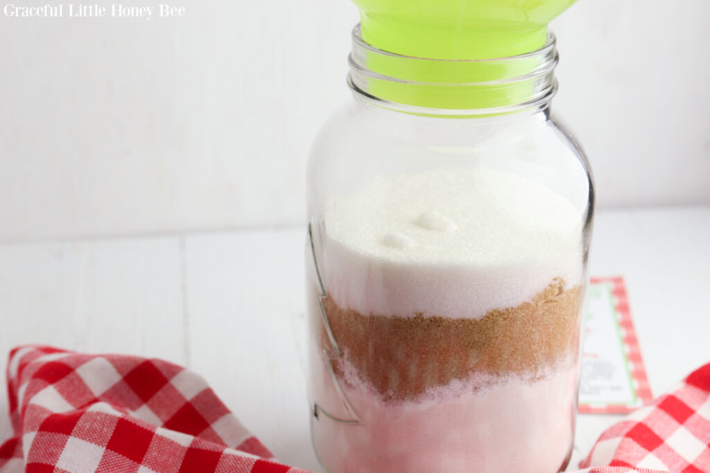 Flour, cornstarch, baking soda. brown sugar and white sugar layered in a quart mason jar.