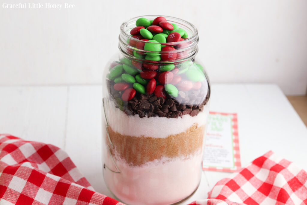 Ingredients for cookies mix layered in a jar before the lid is screwed on.