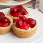 Mini Cherry Cheesecakes in a white plate.