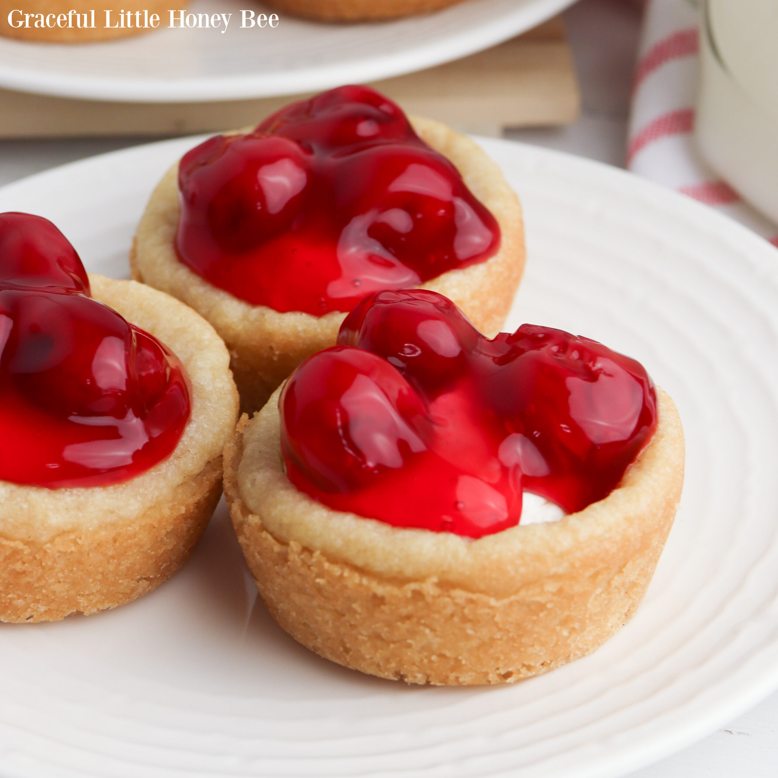 Mini Cherry Cheesecakes in a white plate.