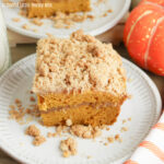 A slice of Pumpkin Spice Coffee Cake sitting on a small, round, white plate.