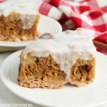 Slice of Cinnamon Roll Casserole on a round white plate.