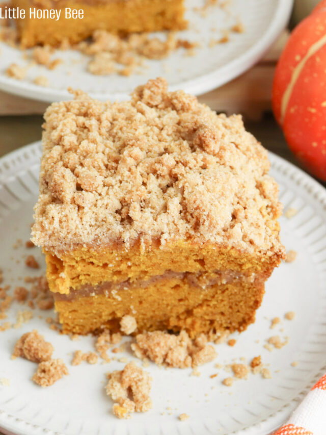 A slice of Pumpkin Spice Coffee Cake sitting on a small, round, white plate.
