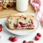 Two slices of Cranberry Pecan Bread on a white plate.