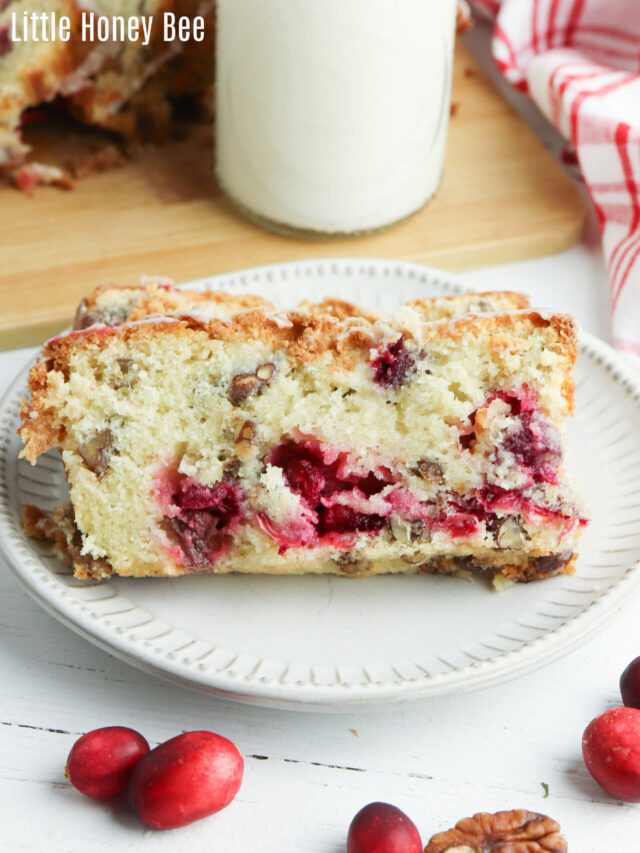 Two slices of Cranberry Pecan Bread on a white plate.
