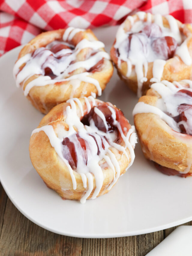 Close up of a Cherry Cheese Danish on a white plate.