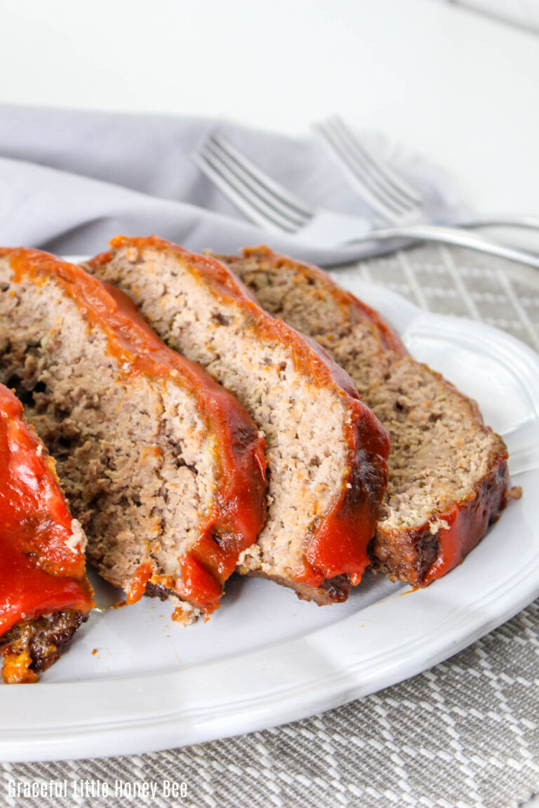 Meatloaf slices on a white plate.