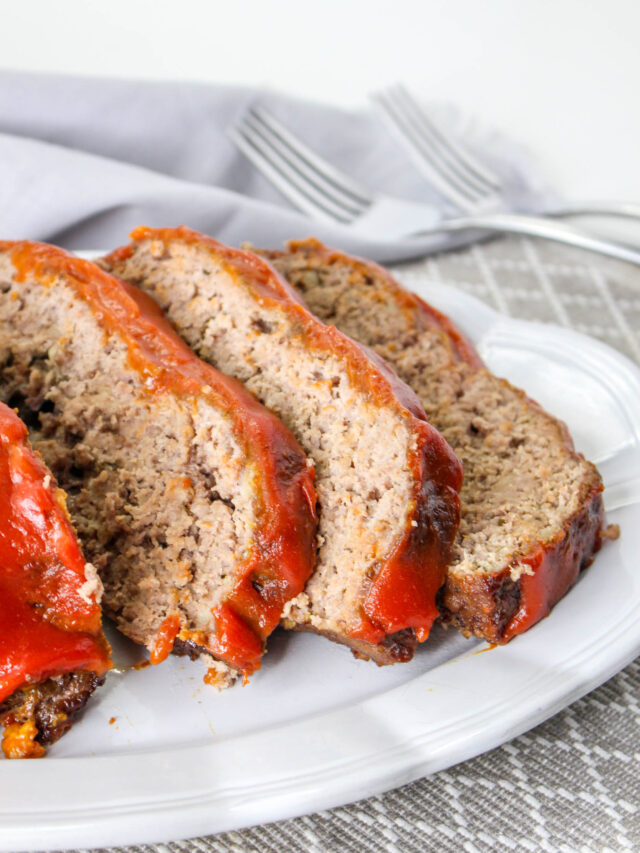 Meatloaf slices on a white plate.
