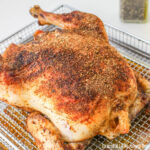 Air fried chicken sitting on the air fryer tray.