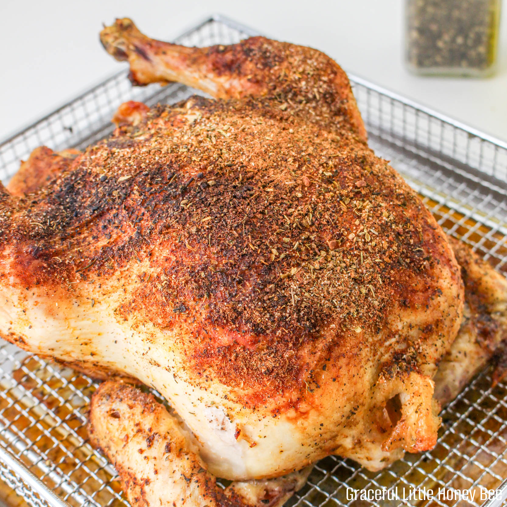 Air fried chicken sitting on the air fryer tray.