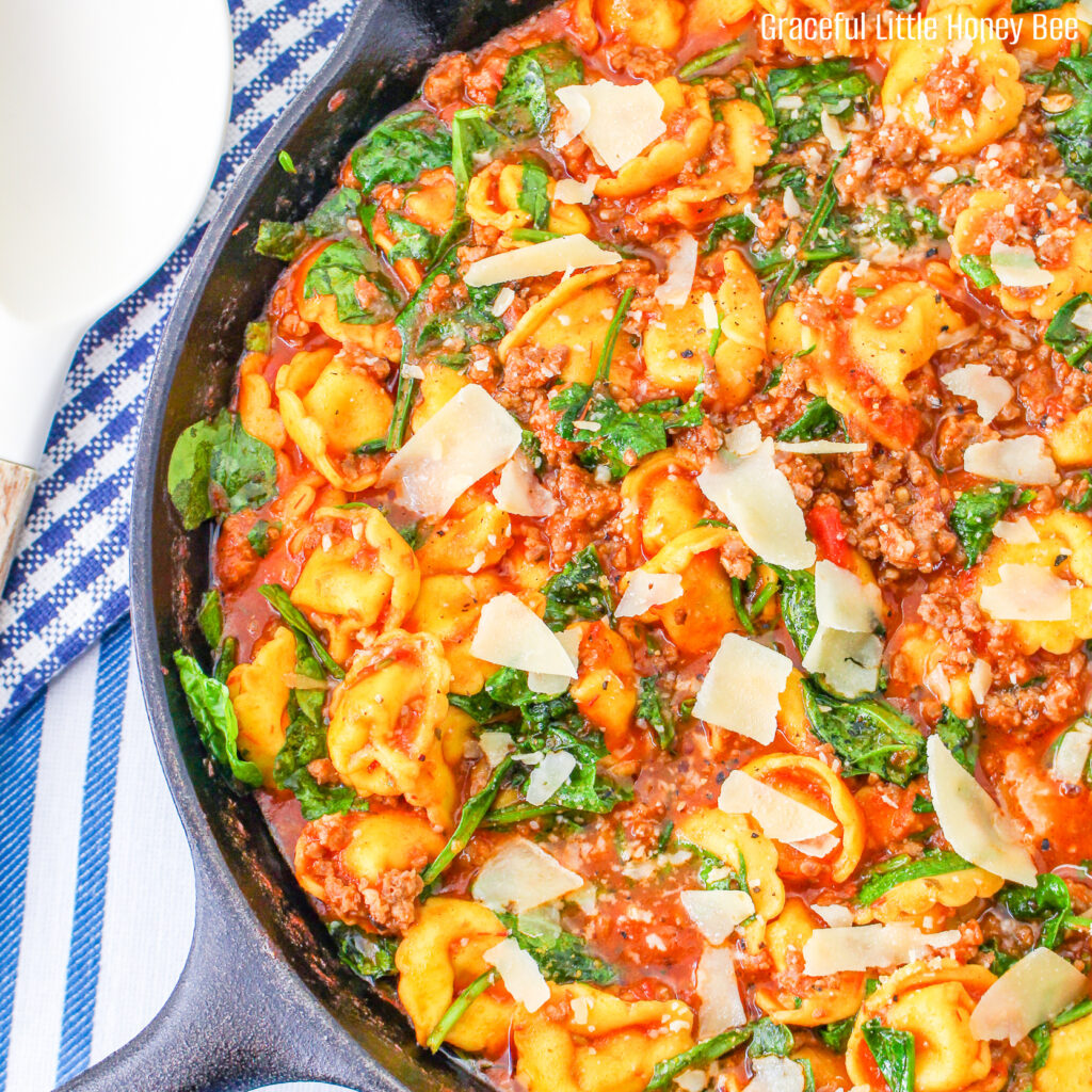 Close up of Sausage Tortellini Skillet in a large cast iron pan.