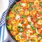 Close up of Sausage Tortellini Skillet in a large cast iron pan.