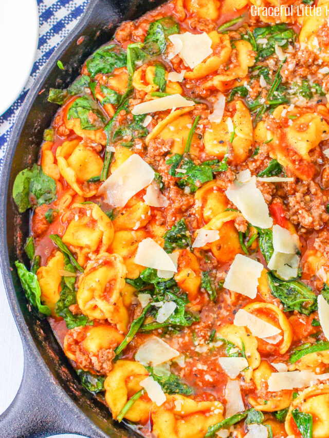 Close up of Sausage Tortellini Skillet in a large cast iron pan.
