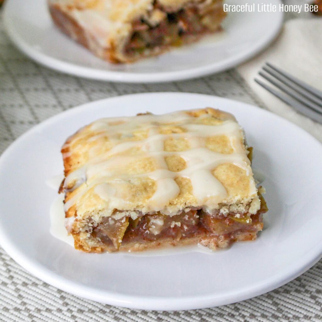 An apple pie bar sitting on a white plate.