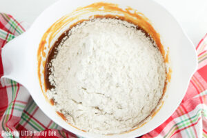 Dry ingredients on top of wet ingredients before being mixed together.