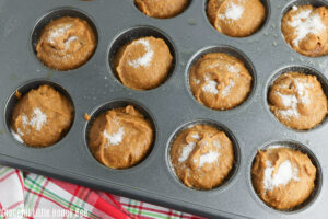 Sugar sprinkled over muffins before going into the oven.