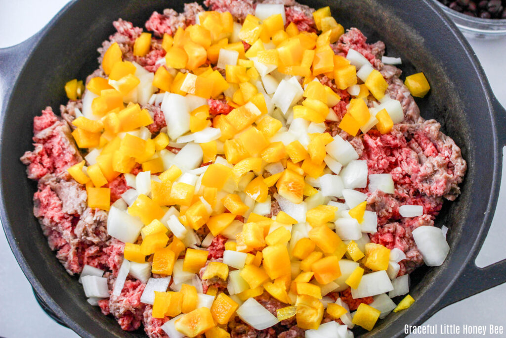 Beef, pepper and onion in a skillet.