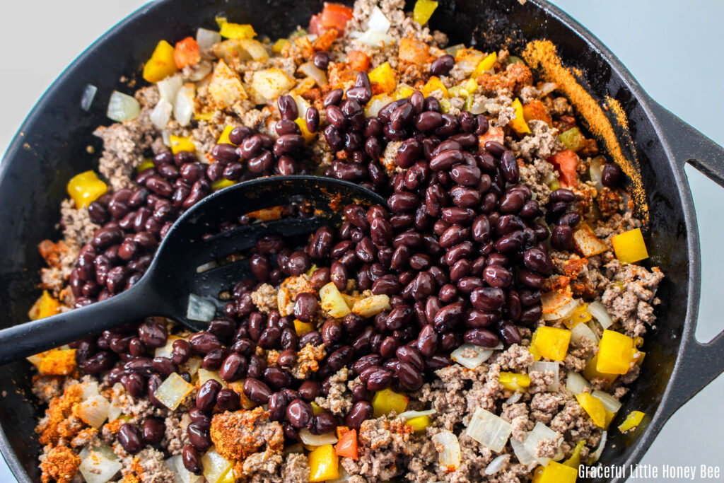 Black beans on top of beef mixture.