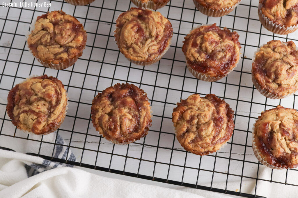 Peanut butter and jelly muffins on a cooling rack.