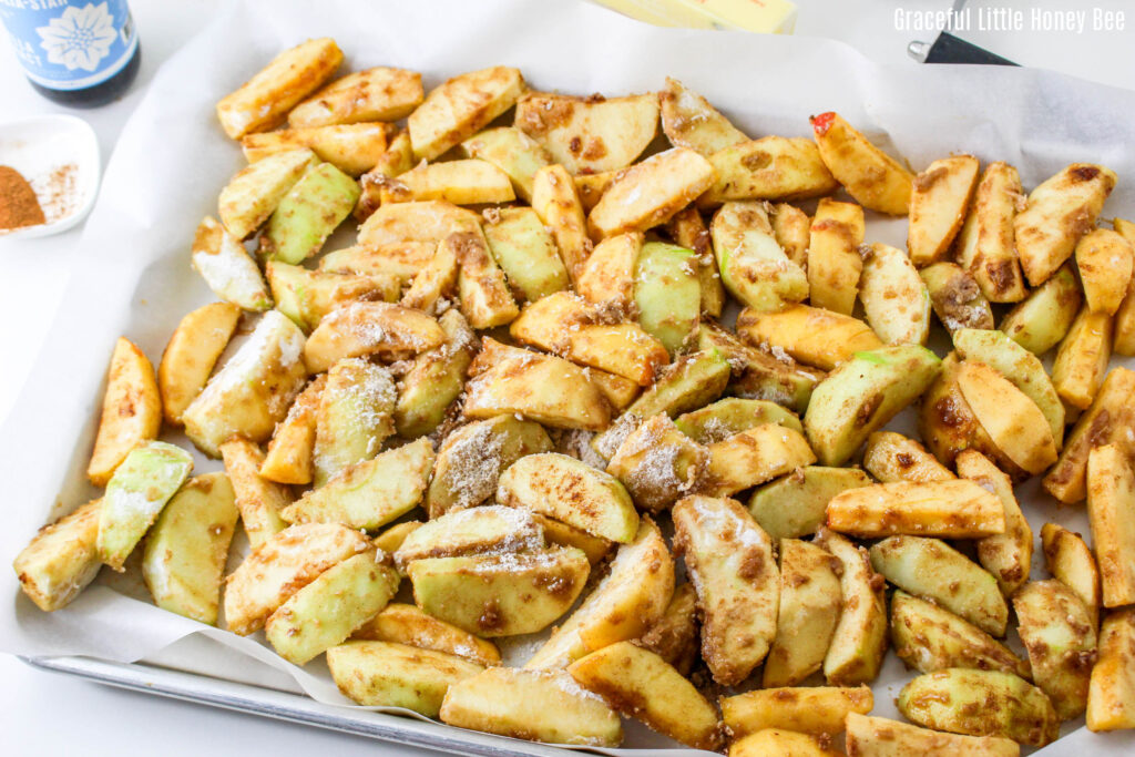 Coated apples on a sheet pan.