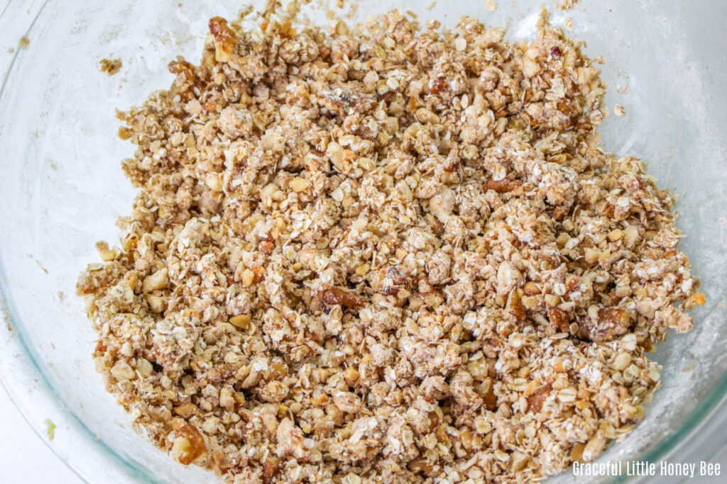 Topping for apple crisp in a clear mixing bowl.