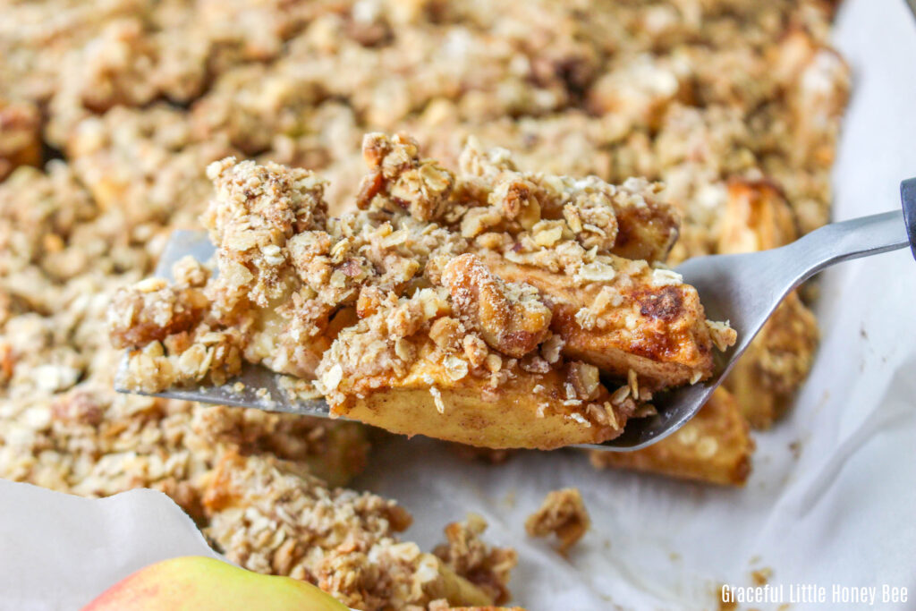 A serving of apple crisp on a serving spoon.