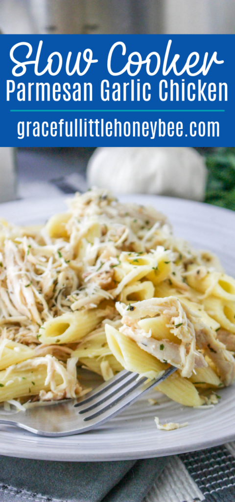 Close up of garlic Parmesan chicken over pasta on a white plate.