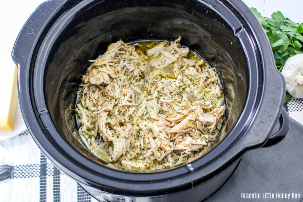 Garlic Parmesan Chicken in a small, round black slow cooker.