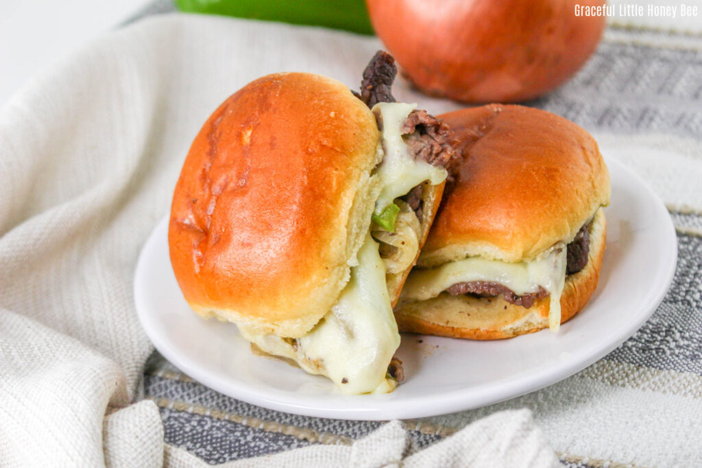 A close up view of two sliders on a white plate.