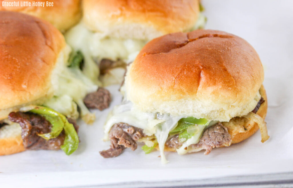 A close up view of a philly cheesesteak slider.