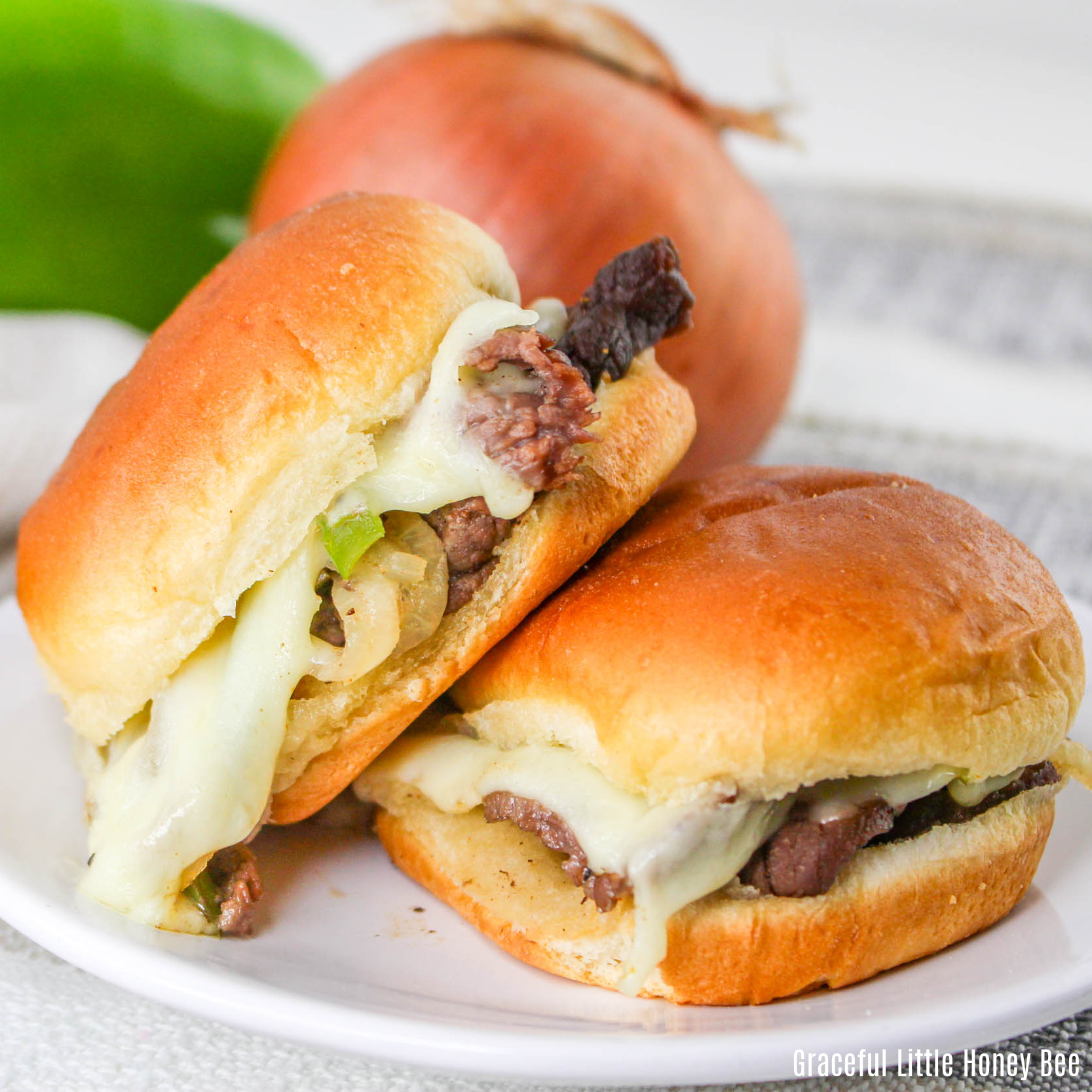 A close up view of two sliders on a white plate.