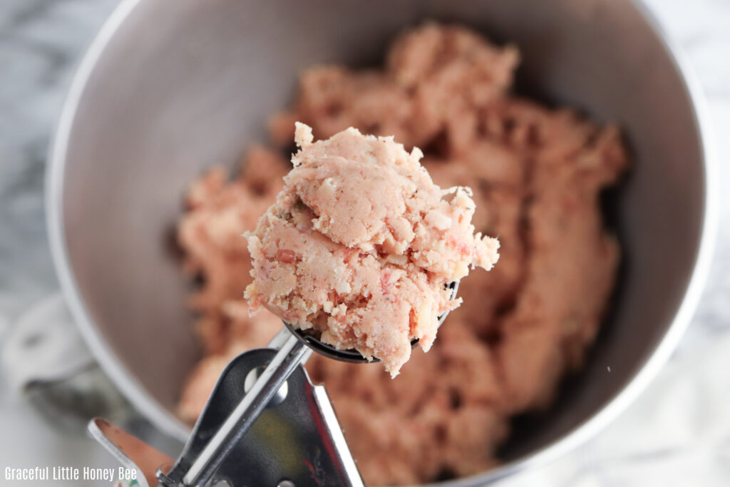 Sausage ball mixture in an ice cream scoop.