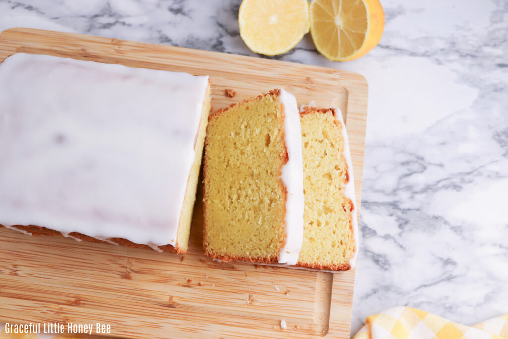 A loaf of lemon bread sitting on a cutting board.