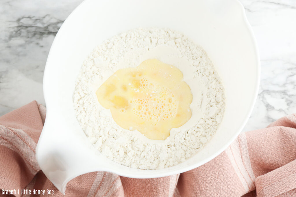 Ingredients for noodles in a white mixing bowl.