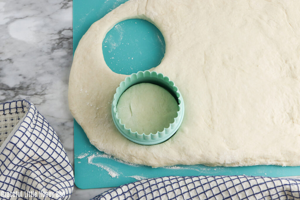 Rolled out dough with a biscuit cutter.