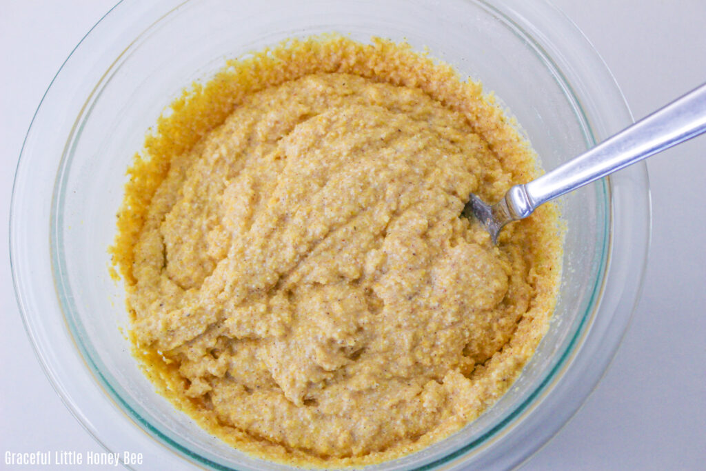 Cornmeal and milk batter in a glass mixing bowl.