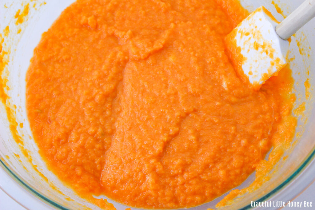 Spoonbread batter in a glass mixing bowl.