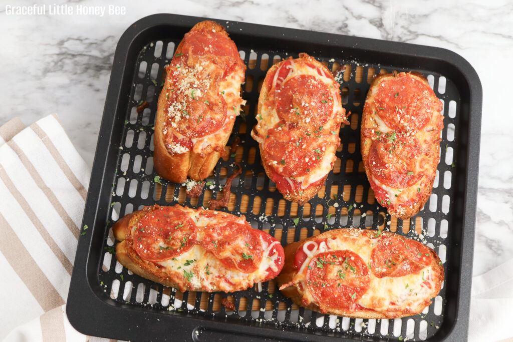 Garlic Bread Pizza on an air fryer basket.