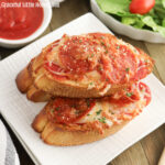 Stack of three Garlic Bread Pizzas on a white plate.