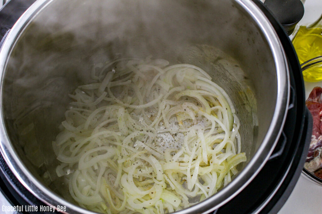 Sliced onions cooking in an Instant Pot.