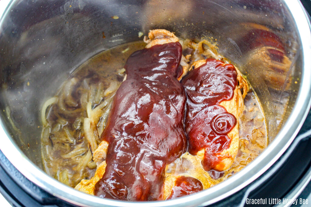 Pork Tenderloin topped with BBQ sauce in the Instant Pot.