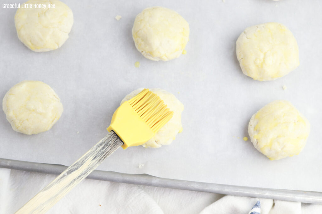 Shortcake dough being topped with and egg wash.
