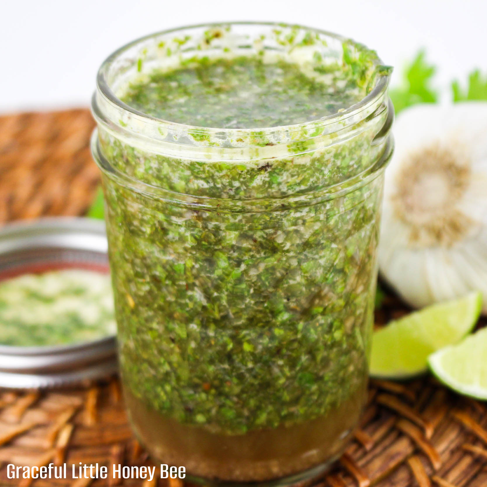 Close up view of a mason jar full of chimichurri sauce.