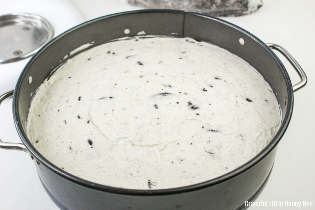 Cheesecake mixture in a spring form pan before crumbs are added on top.