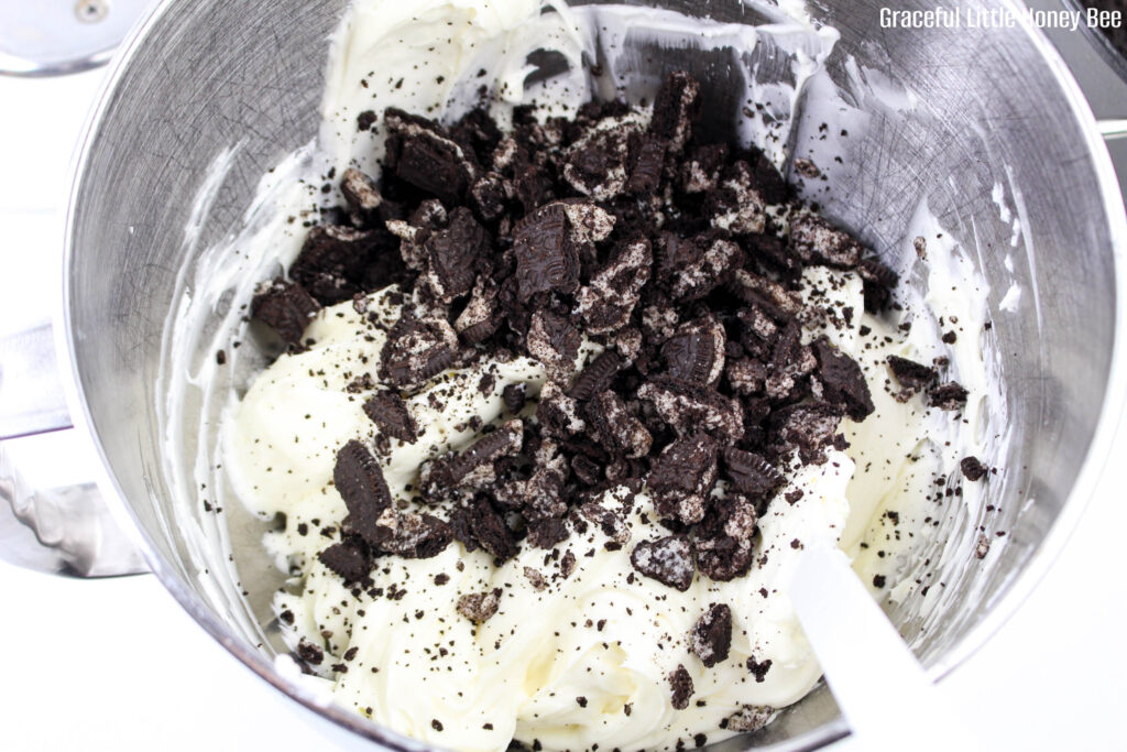 Cream cheese mixture with cookie crumbs in a stand mixer.
