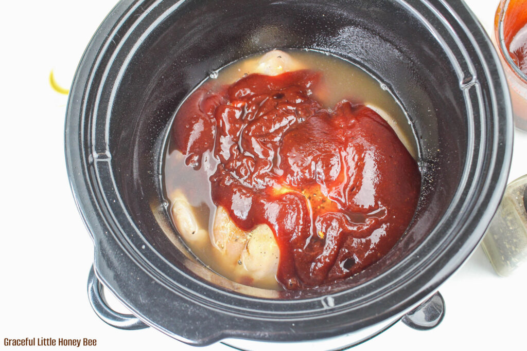 Chicken, broth, seasoning and bbq sauce in slow cooker.