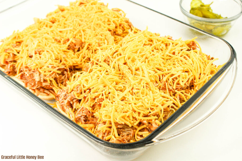 9x13 dish with slider bottom buns, shredded chicken and shredded cheese.